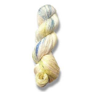 Handgefärbte PURE NATURE Silk WamM Wolle in sanften Creme-, Grün- und Blautönen, inspiriert von einer blühenden Wiese im Morgentau.